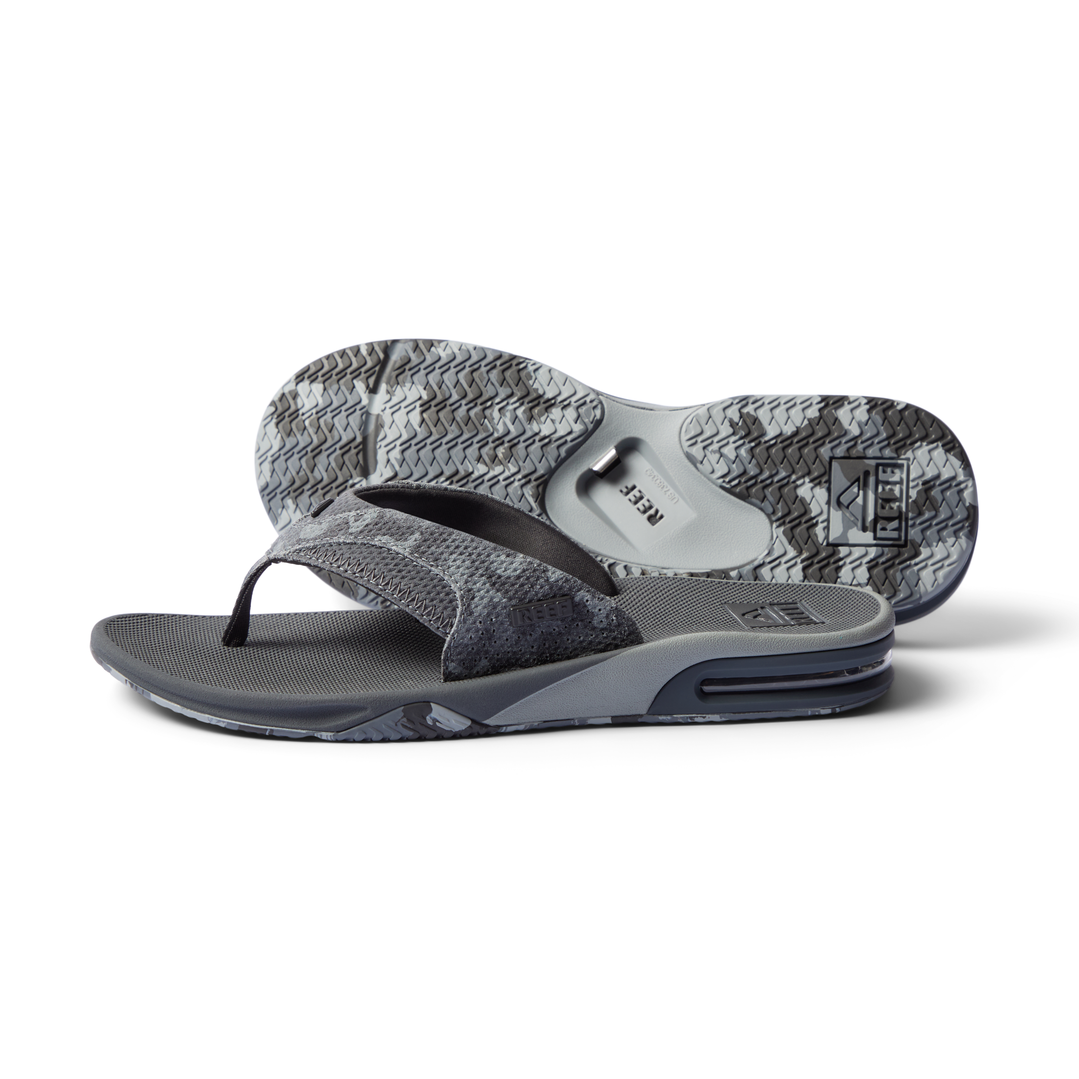 Fanning men's grey flip flop facing left, close-up on sole and cushioned footbed with anatomical arch support.