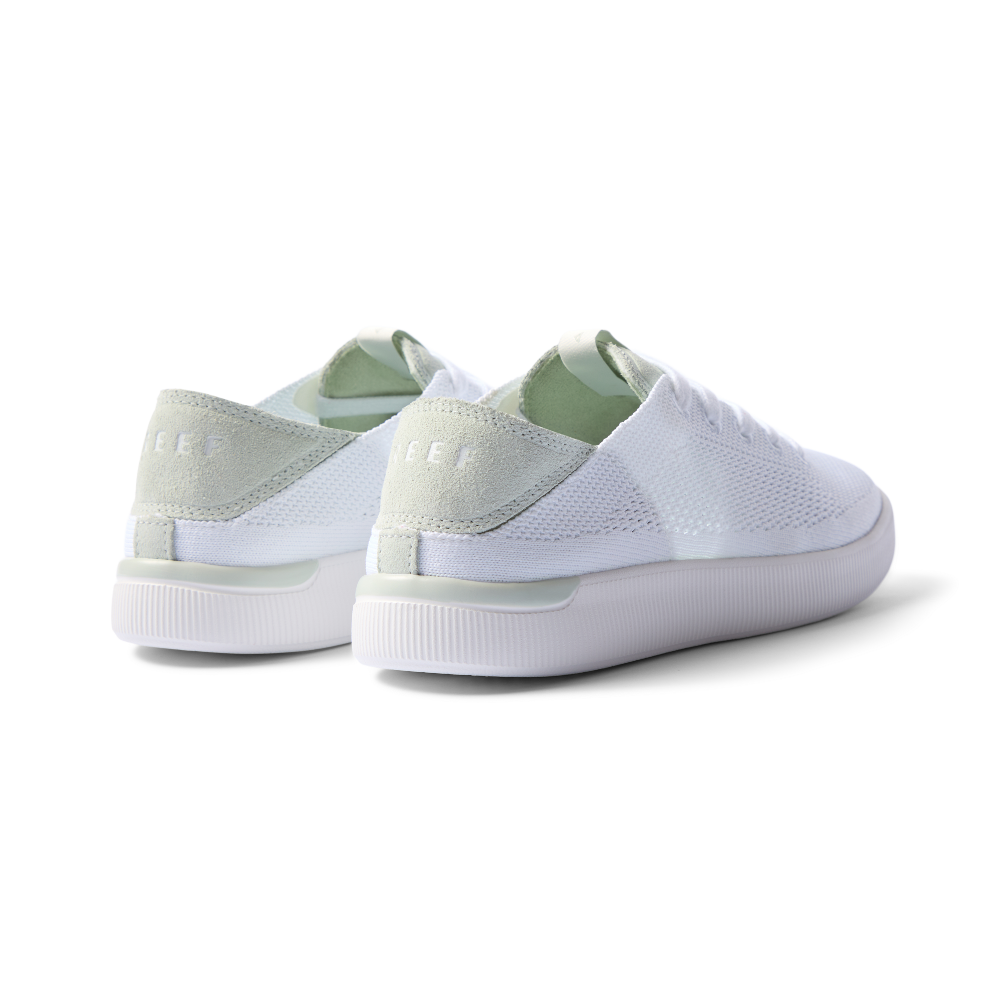 Reef Neptune women's sneakers showing rear and lateral sides facing left in white and dusty sage with cushioned arch support.