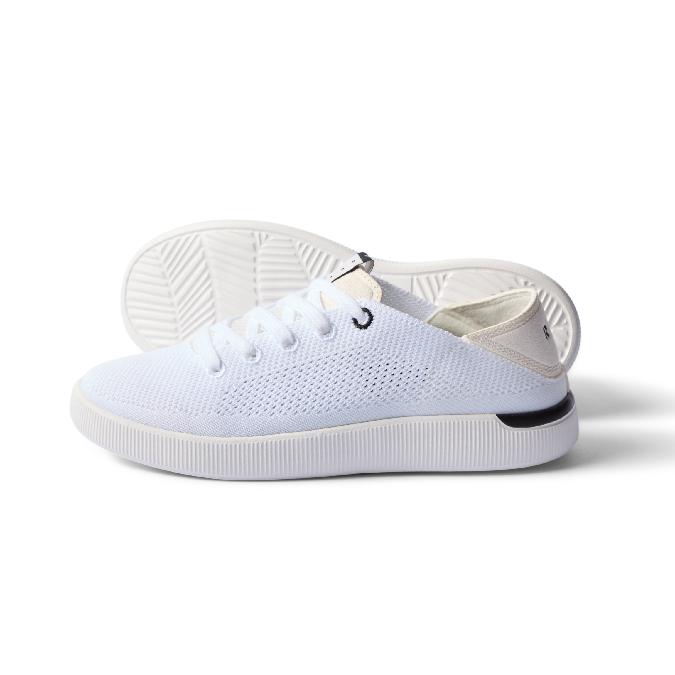 Reef Neptune women's white and black sneaker with breathable knit, anatomical arch support, and cushioned sole facing left side.