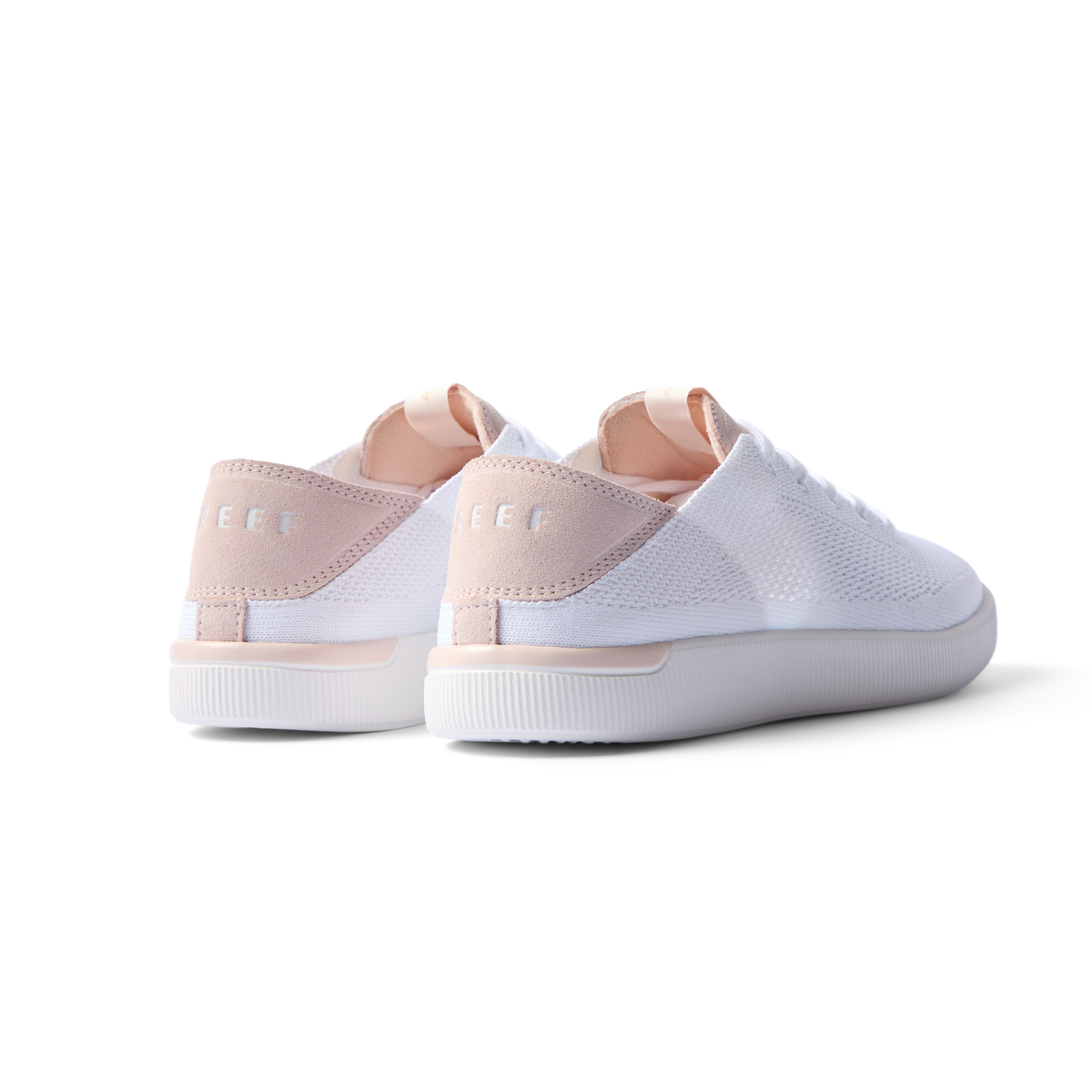 REEF Neptune women's white and blush sneakers facing backward showing heel with anatomical arch support and cushioning.
