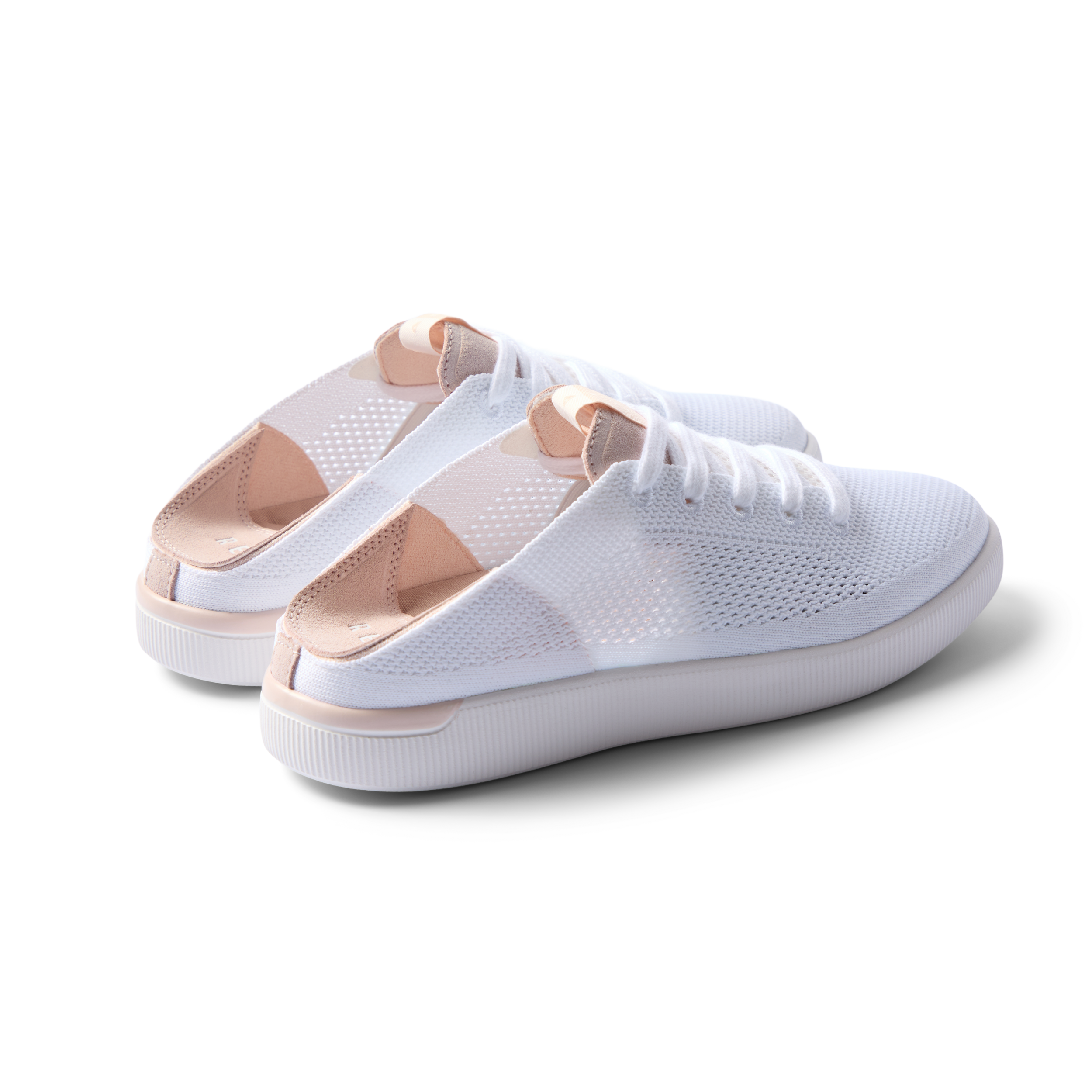 Reef Neptune women's white blush sneakers facing right, showing heel and side with breathable knit upper and cushioned sole.