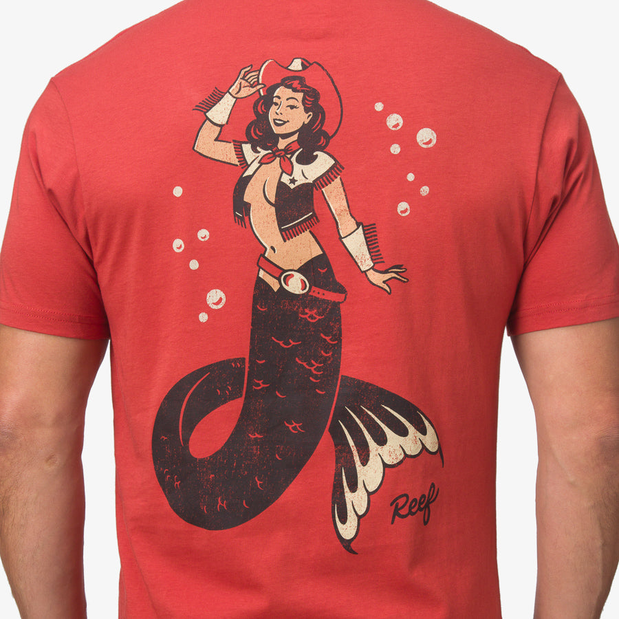 Back view of men’s Cowmaid Tee in cinnabar red showing surf-inspired mermaid cowboy graphic and REEF logo