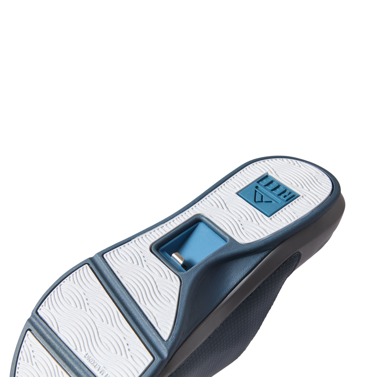 Solid Cruiser Slide men's sandals showing the navy blue and white sole facing upward with arch support detail visible