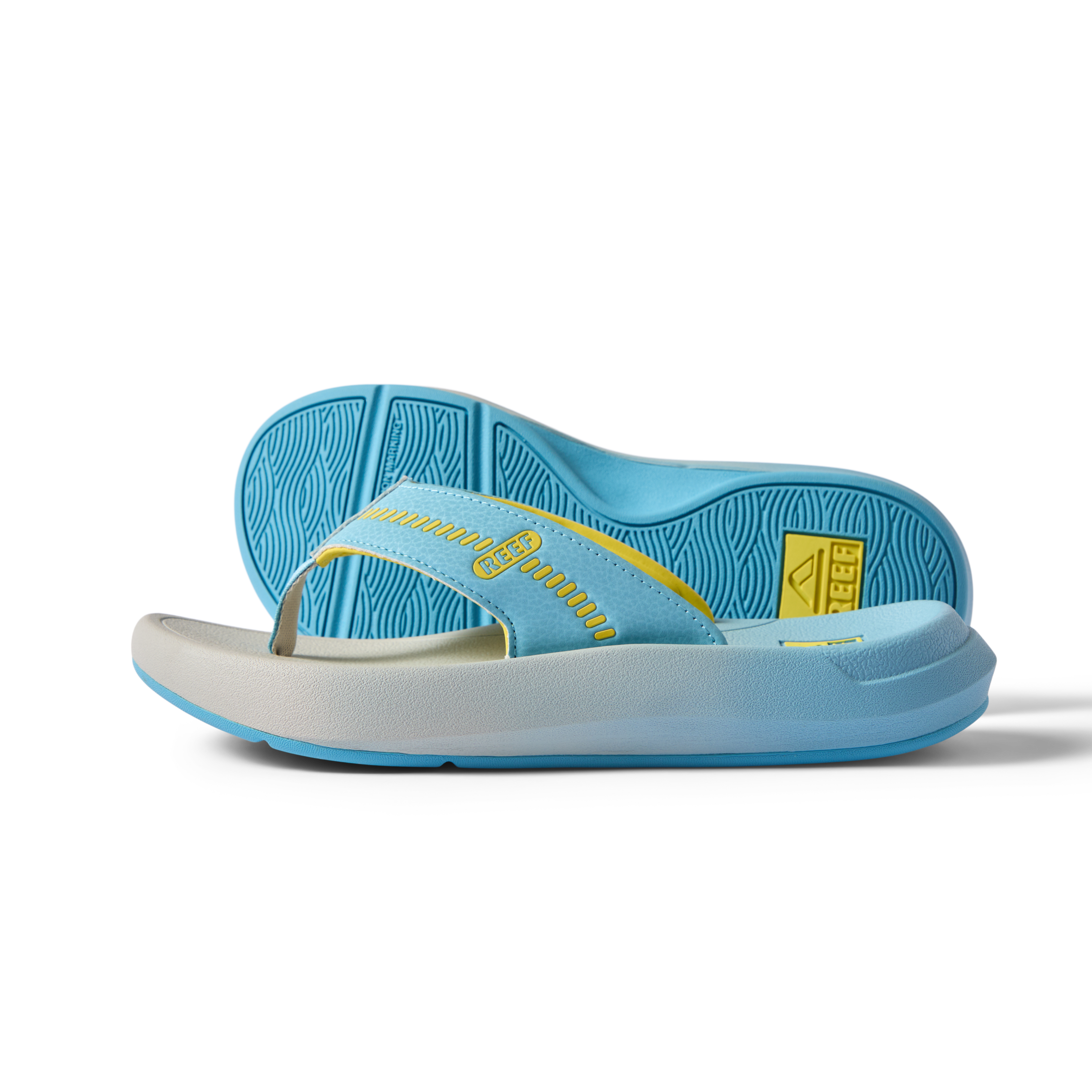 Cruiser men's flip flop sandal facing right with a close-up of the sole, light blue and yellow, surf-inspired comfort