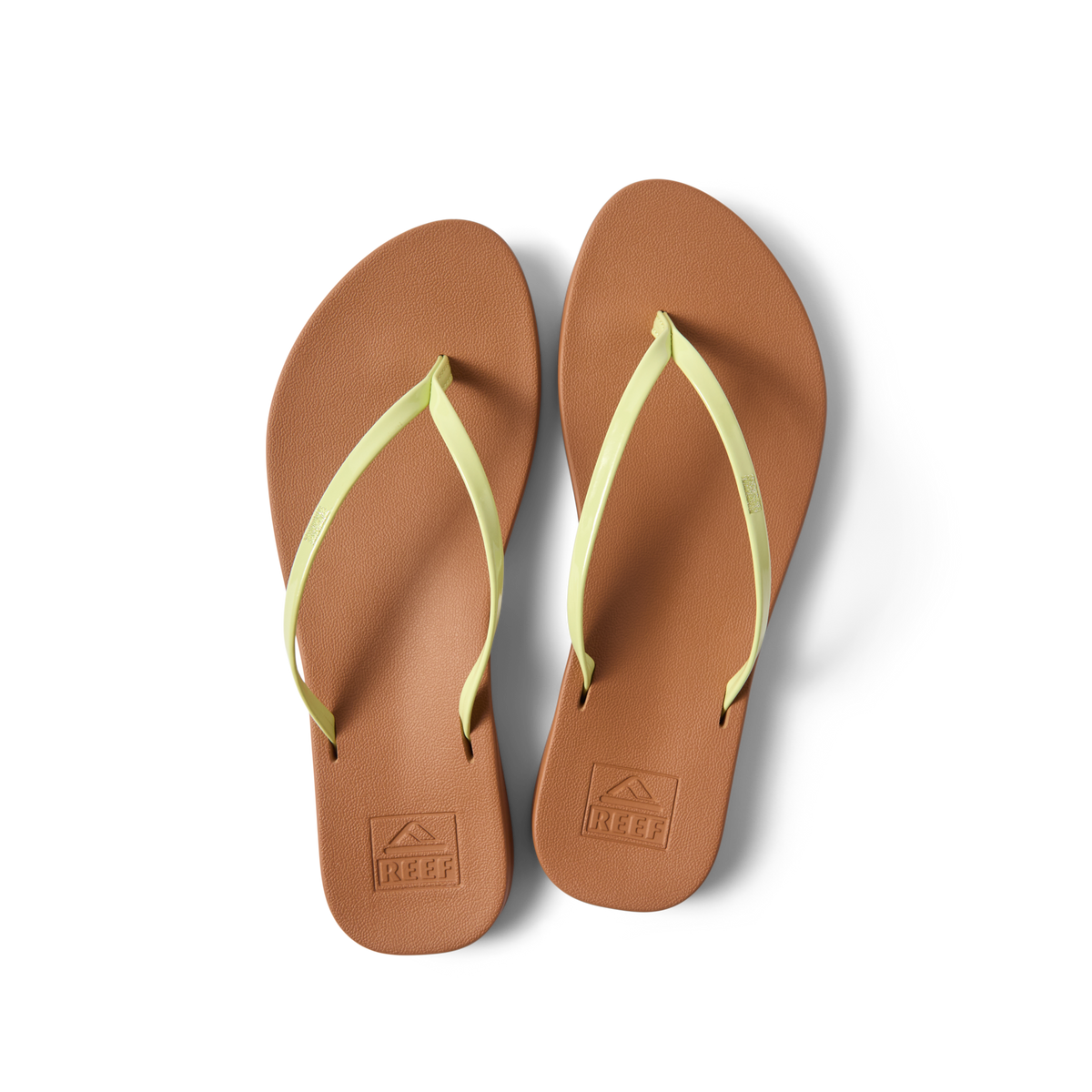 Pair of Cushion Slim flip flops for women, top view showing brown footbed and lime sherbert straps facing upward.