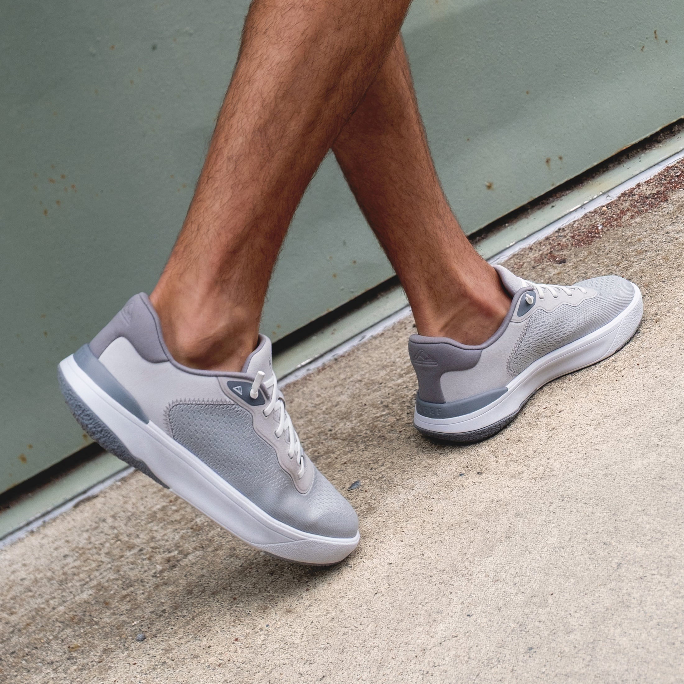 Shoreline Del Mar sneakers facing right on feet, light grey with cushioned sole and breathable mesh, beach-inspired comfort