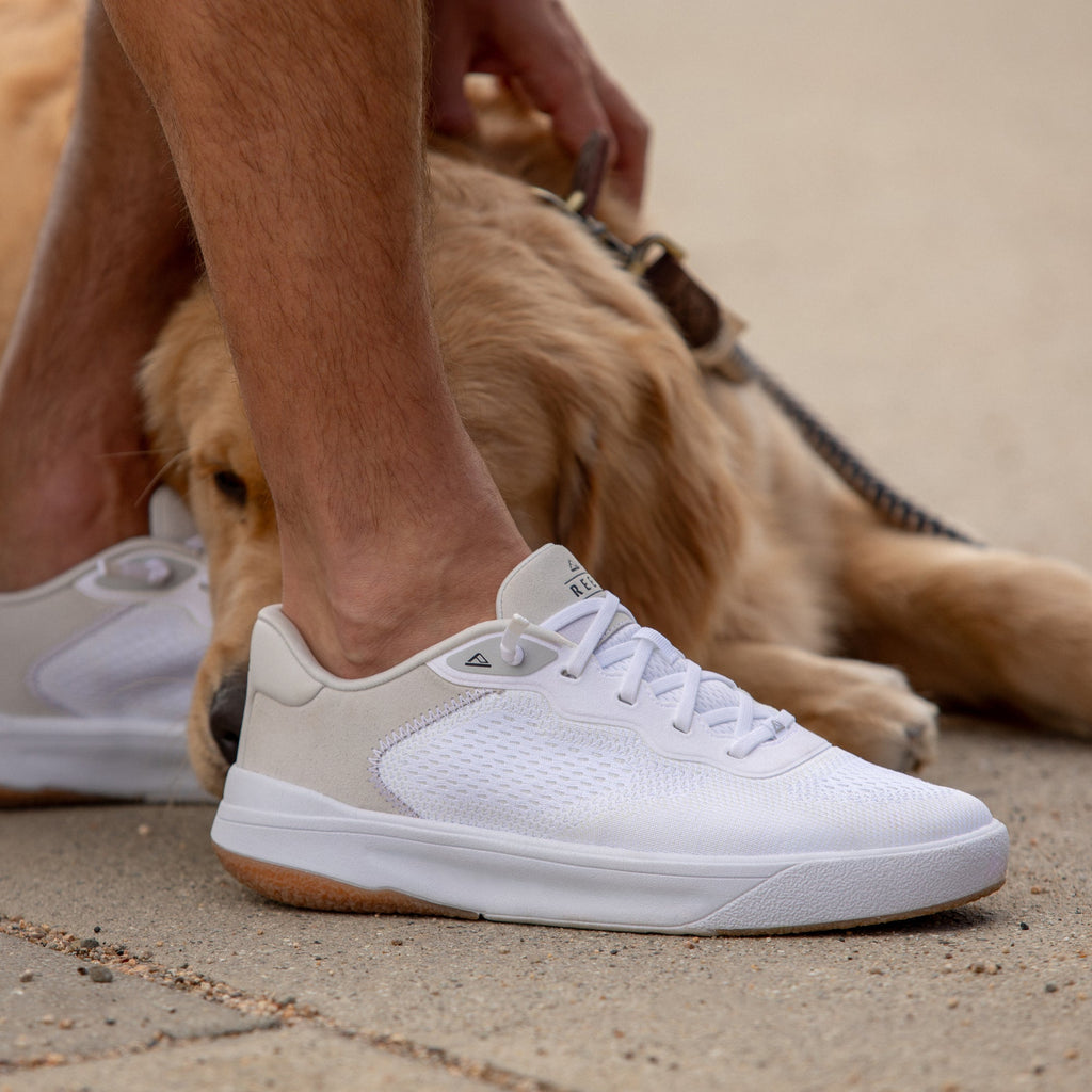 Shoreline Del Mar sneaker facing left, white breathable upper with cushioned sole, elastic laces, beach-inspired comfort design.