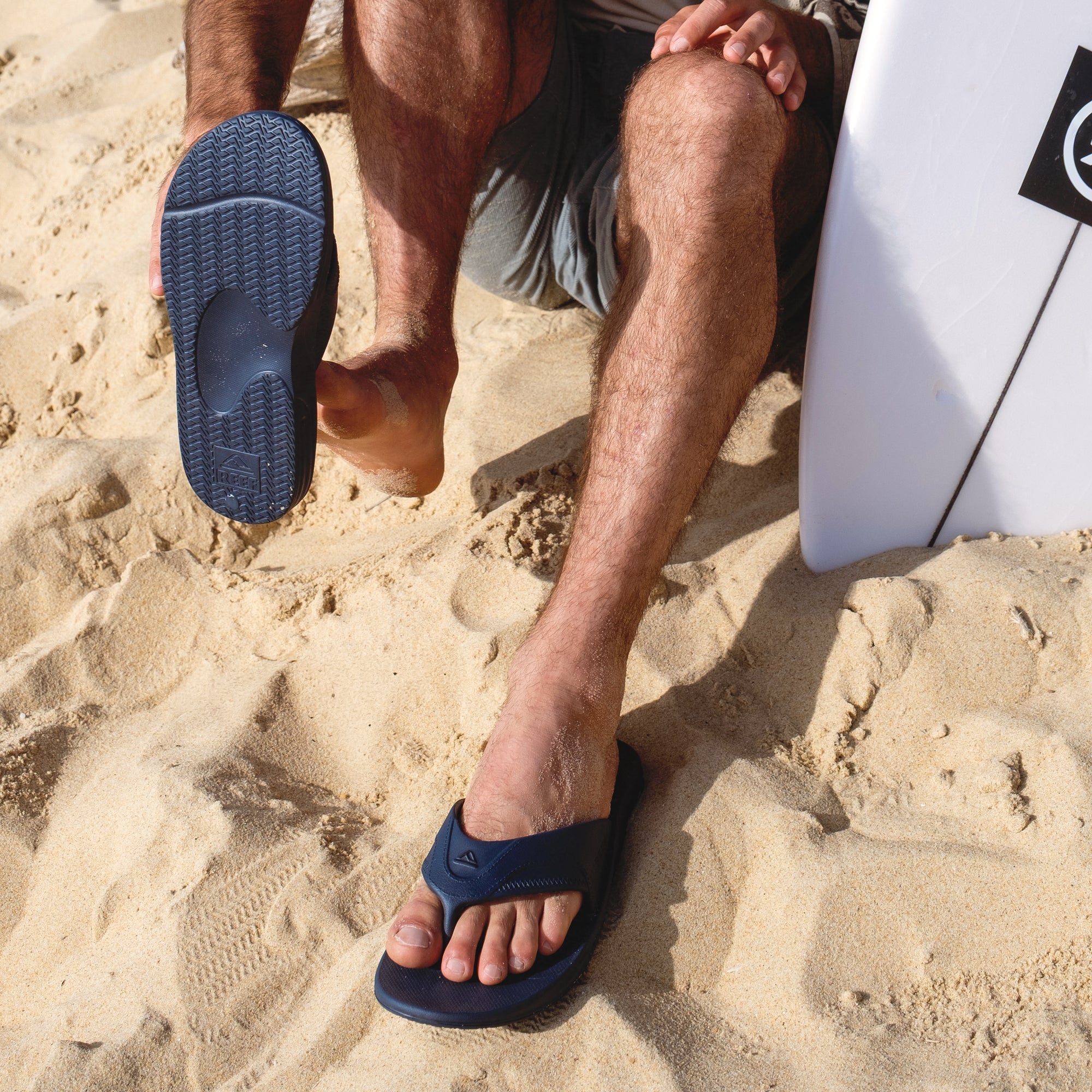 Fanning H2O facing forward, men's blue water-friendly sandal with molded footbed and anatomical arch support on beach sand.
