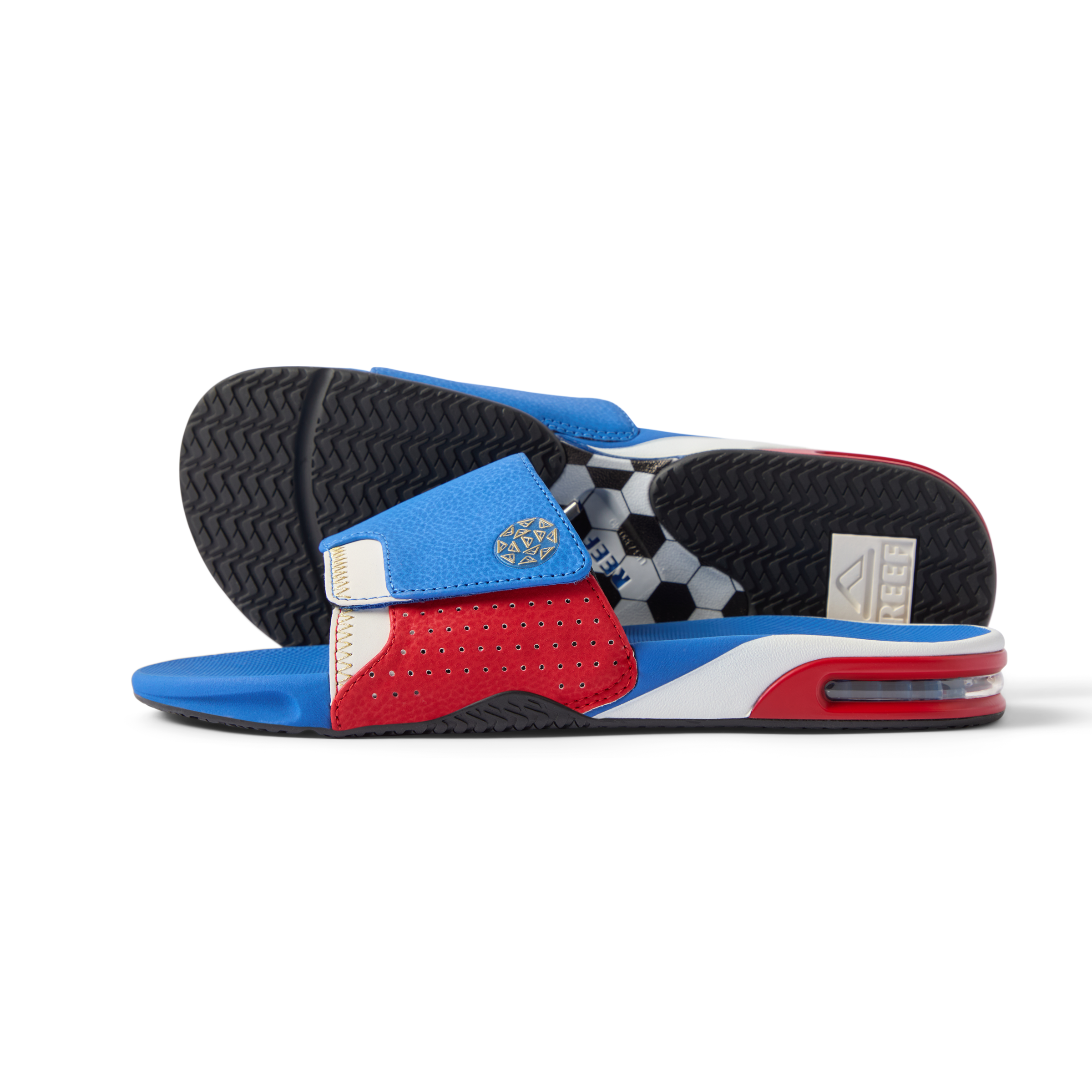 Pair of Fanning Slide sandals facing right with red, white, and blue water-friendly upper and cushioned EVA footbeds.