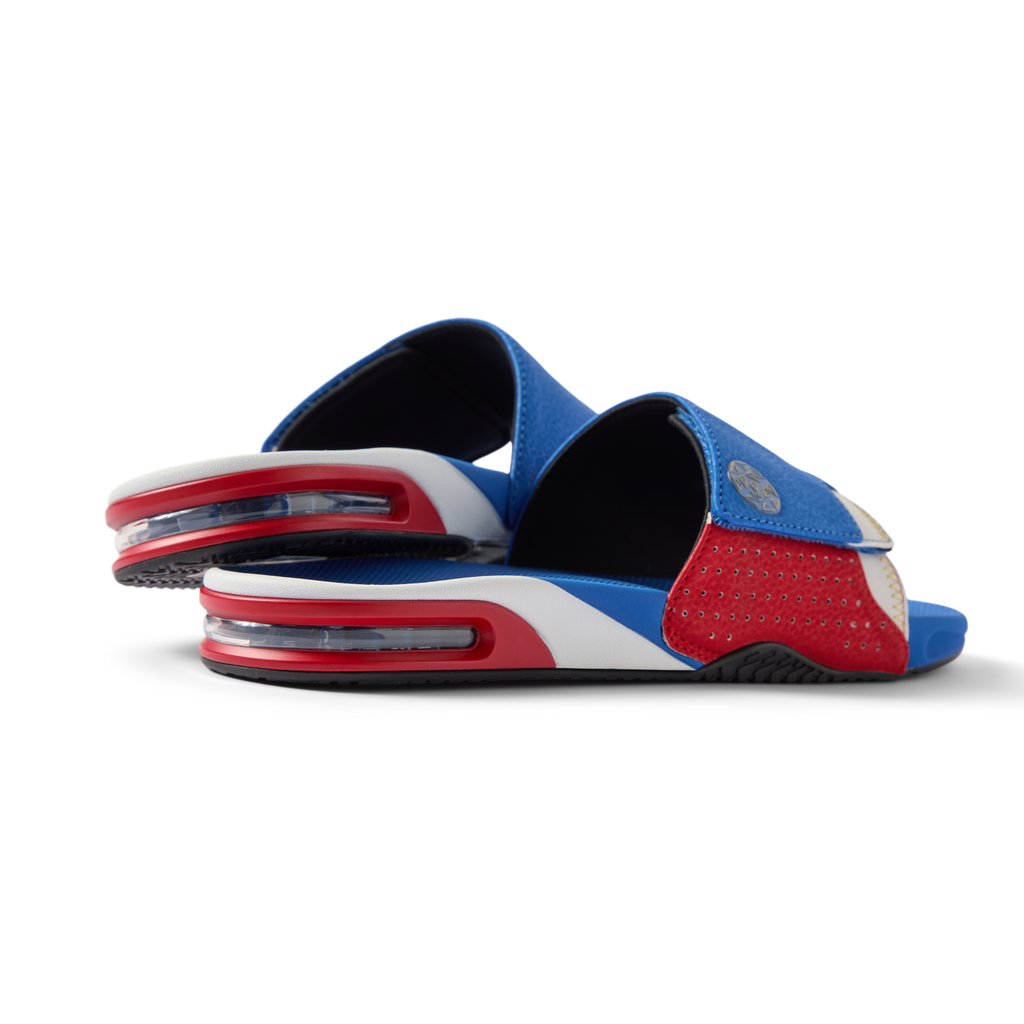 Pair of Fanning Slide sandals facing left, men's water-friendly slides with cushioned EVA footbed and red, white, and blue upper.