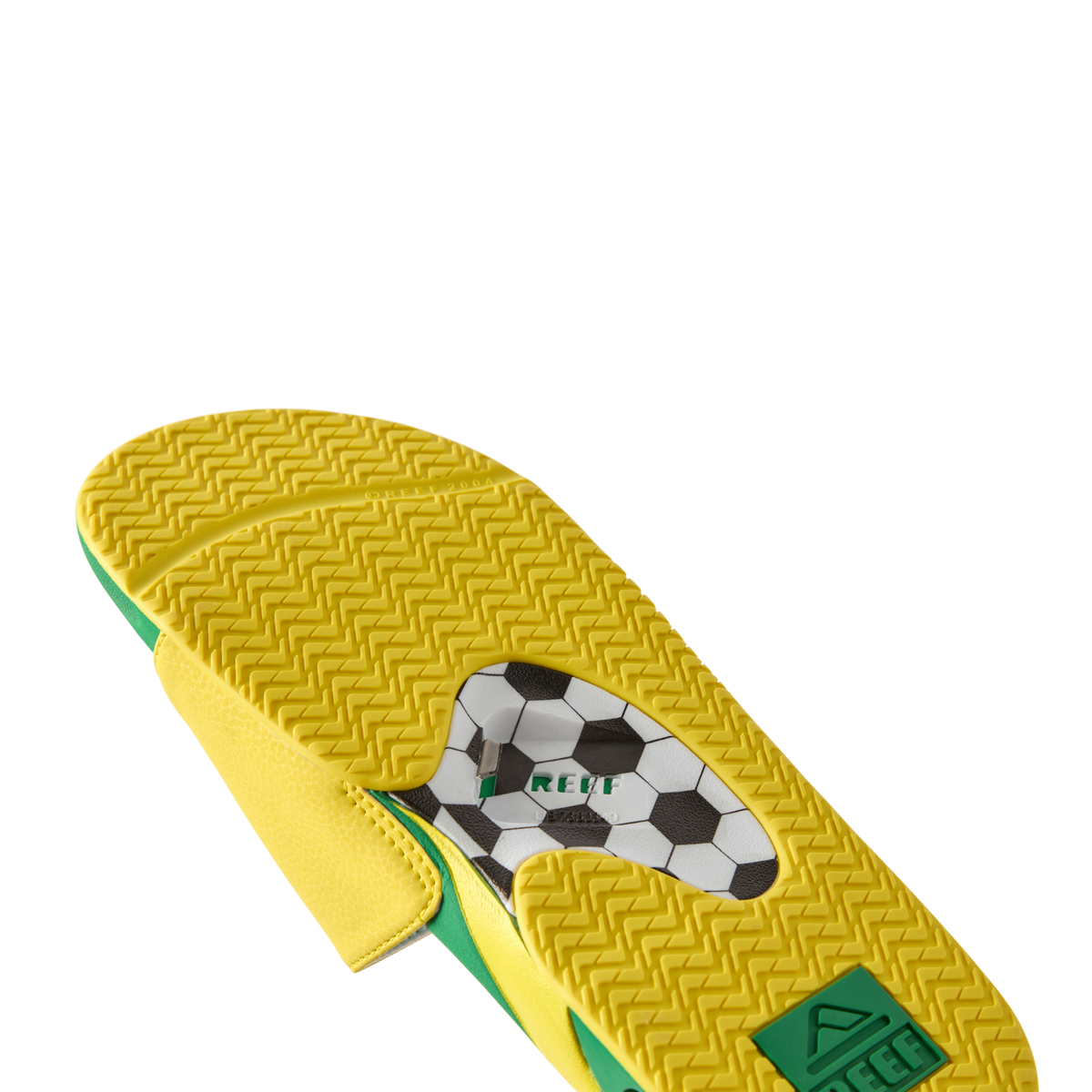 Fanning Slide men's sandal sole facing up with yellow and green water-friendly EVA footbed and soccer ball graphic logo