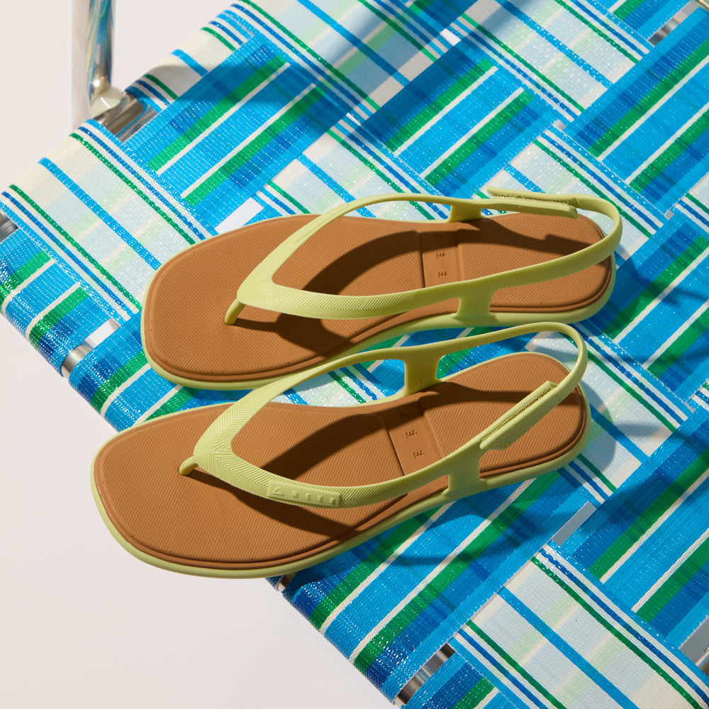Water Willow Maya sandals facing upward on a beach chair, showing straps and cushioned footbed for all-day comfort.