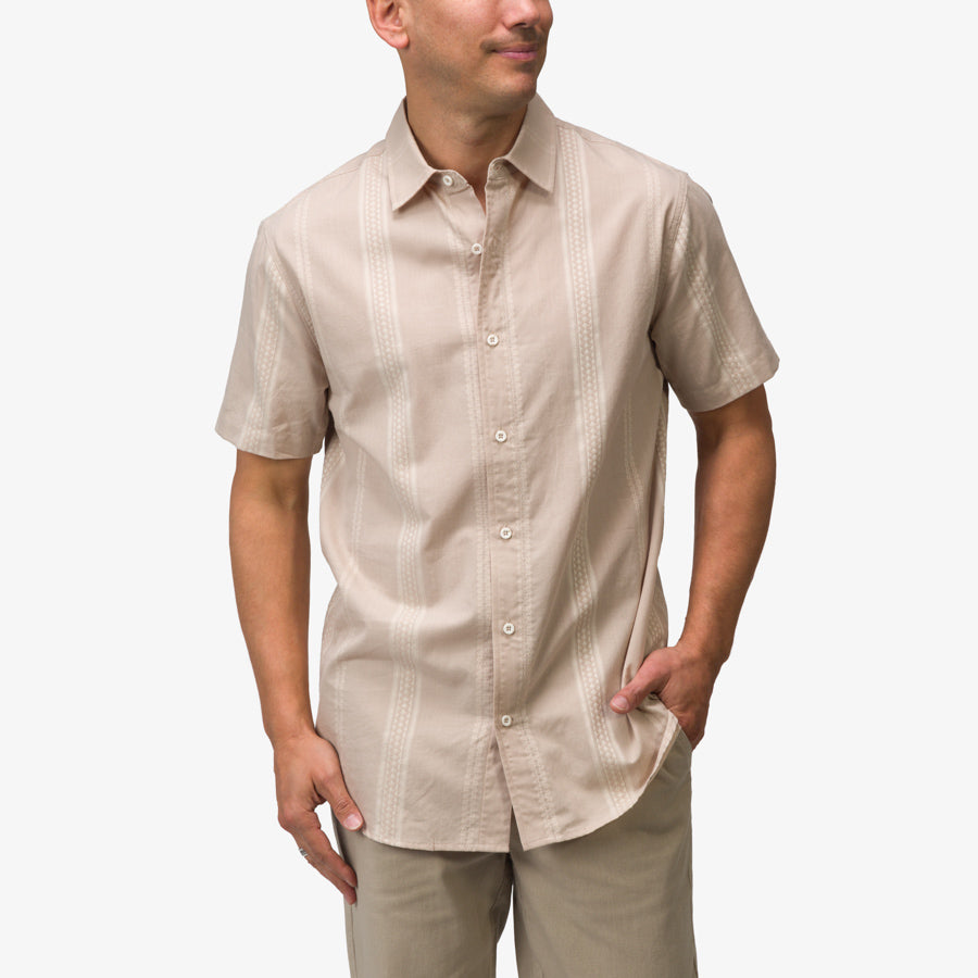 Man wearing a taupe Felton Shirt with subtle vertical patterns, hand in pocket, facing slightly right, casual fit.