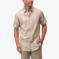 Man wearing a taupe Felton Shirt with subtle vertical patterns, hand in pocket, facing slightly right, casual fit.