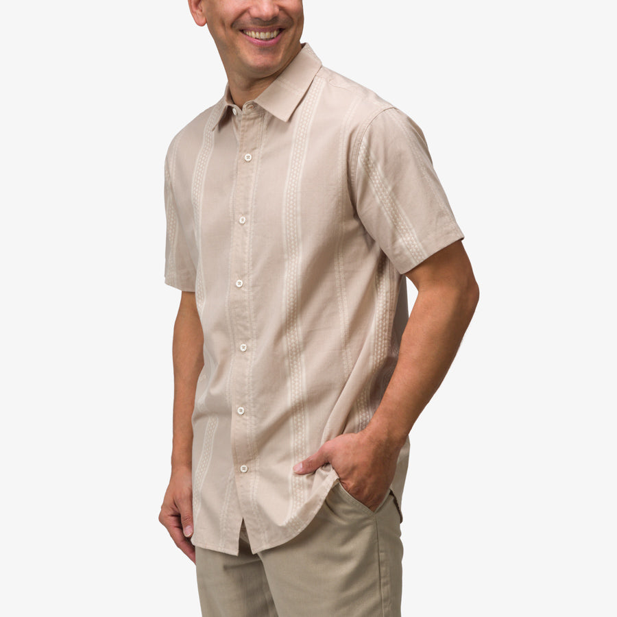 Man wearing a taupe Felton Shirt with short sleeves and subtle pattern, posing with right hand in pocket smiling