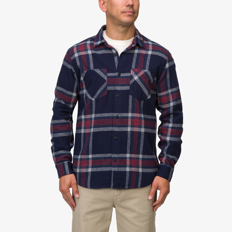 Man wearing a Houston Flannel Shirt in navy with red and gray plaid, front view showing button details and chest pockets.