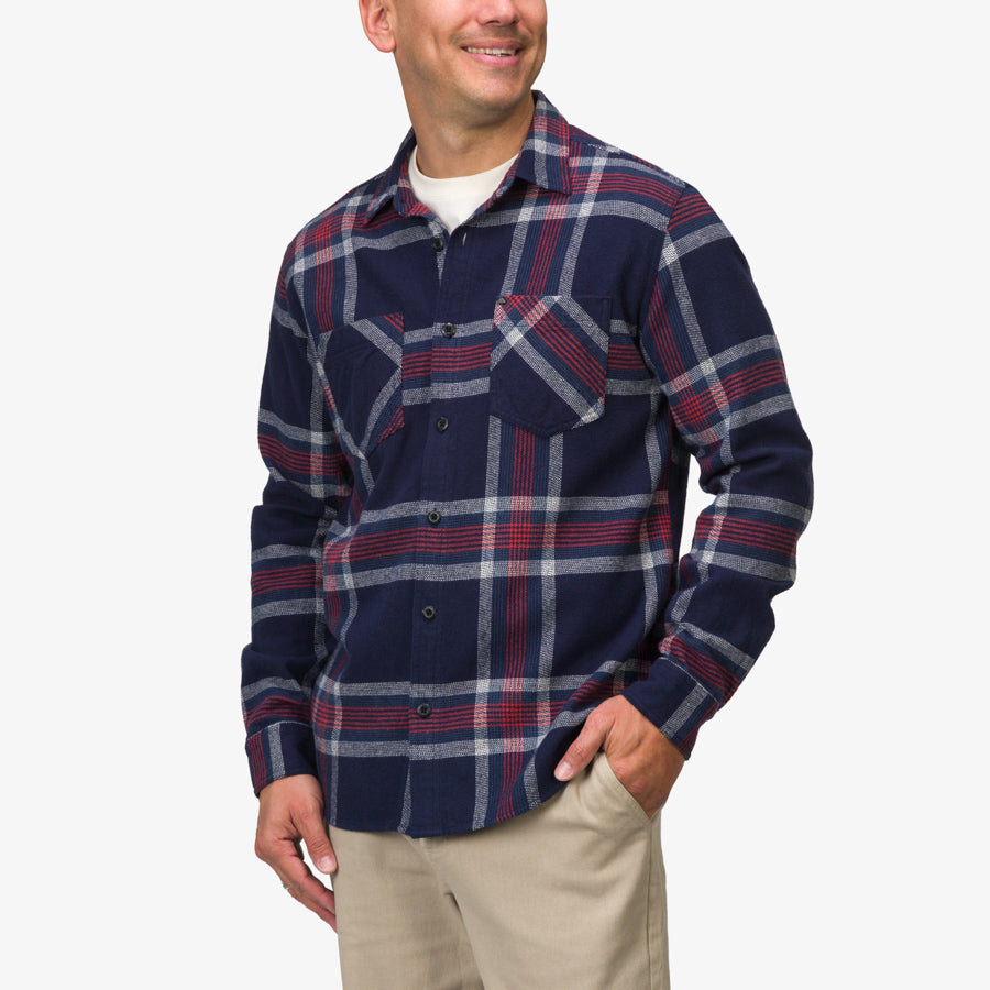 Man wearing Houston Flannel Shirt in navy and red plaid, front view, styled casually with khaki pants, smiling confidently.