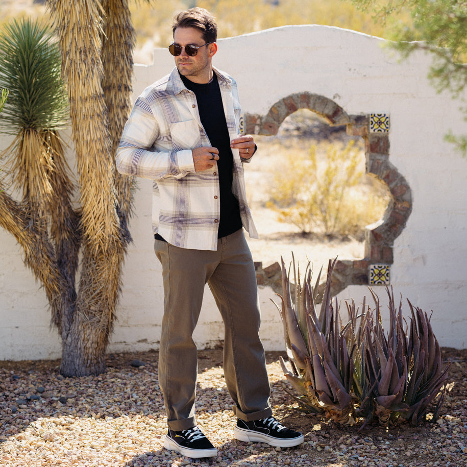 Man wearing the Houston Flannel Shirt outdoors, styled casually with sunglasses in a desert-like setting.