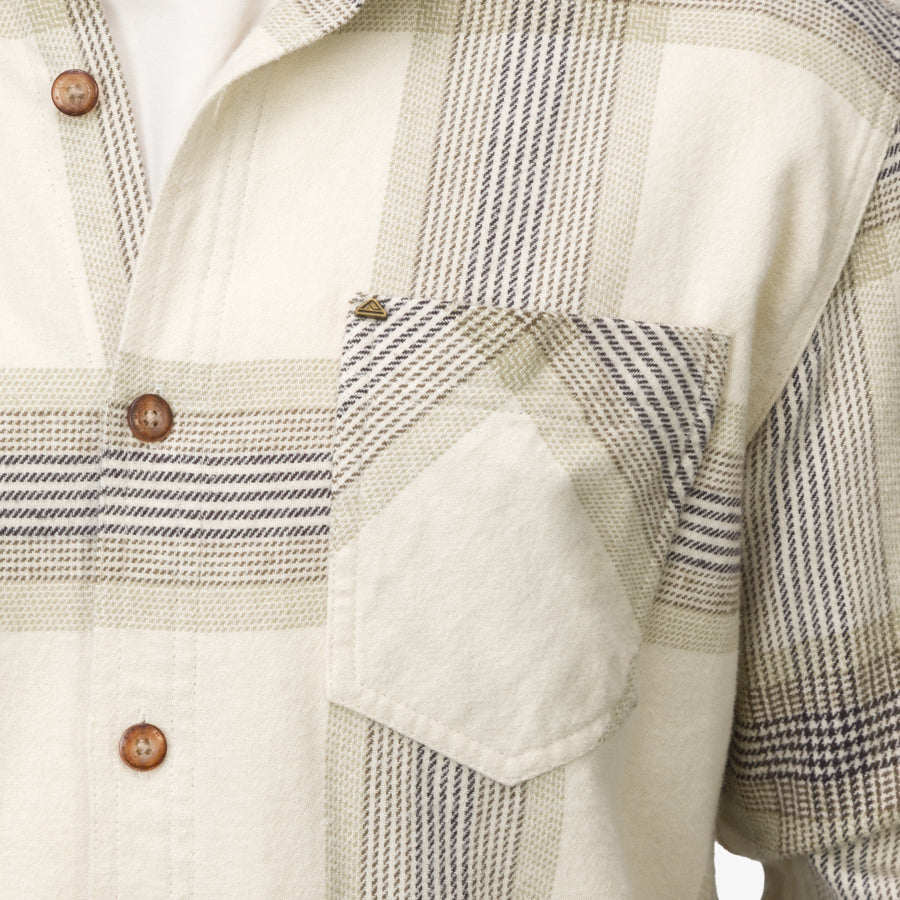 Close-up of the pocket and buttons on the Houston Flannel Shirt in almond milk with a soft plaid pattern.