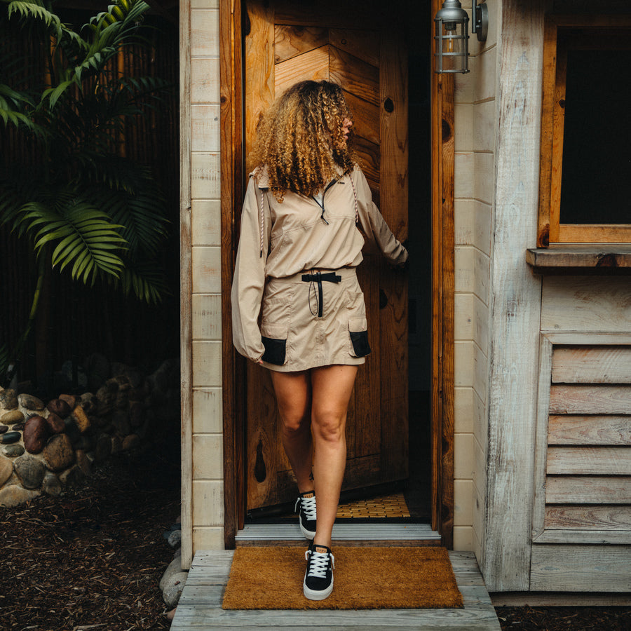 Woman wearing Cargo Skort with black and beige sneakers facing forward, beach-inspired casual apparel for active lifestyles.