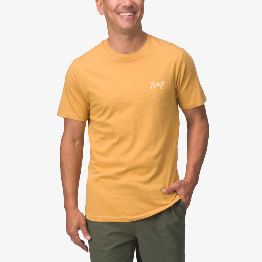 Jacob Tee in honey mustard on a smiling man, front view, showcasing comfortable surf-inspired casual apparel.