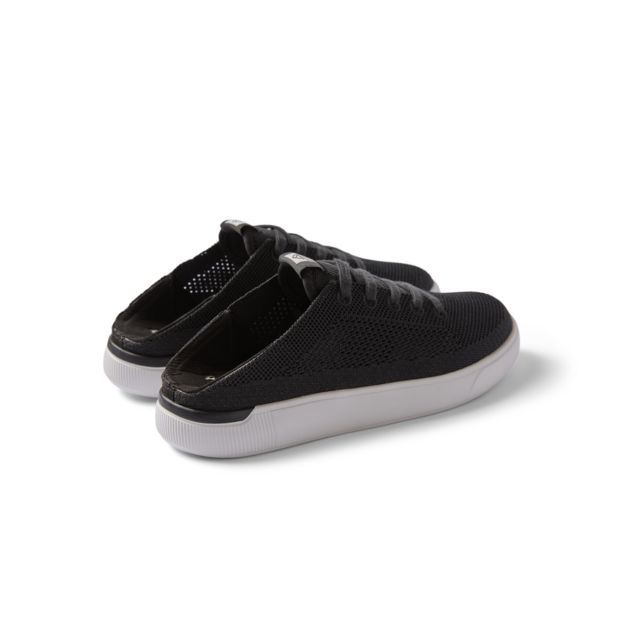 Kids Neptune black slip-on sneakers facing left showing side and heel with breathable knit upper and cushioned sole.