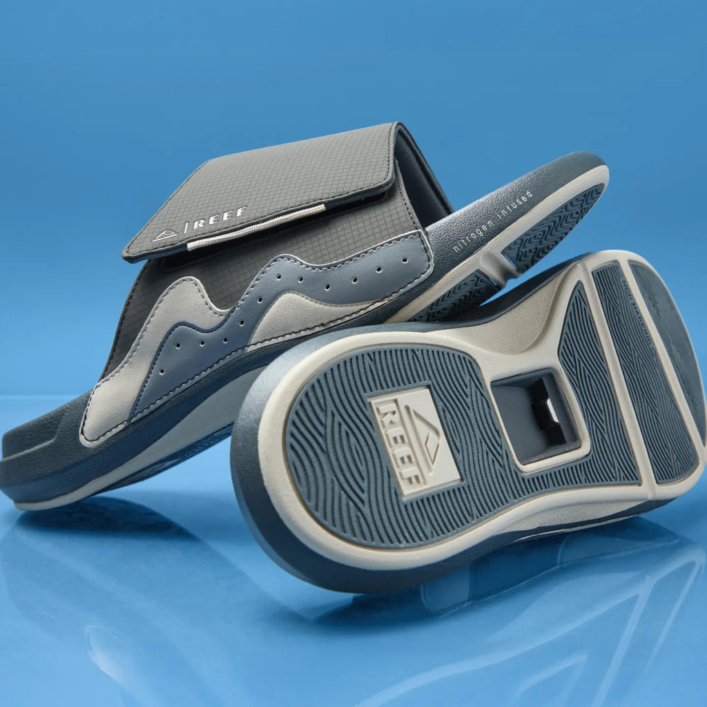 Cruiser Slide in deep grey facing right, showing sole and side, with anatomical arch support and soft cushioning.