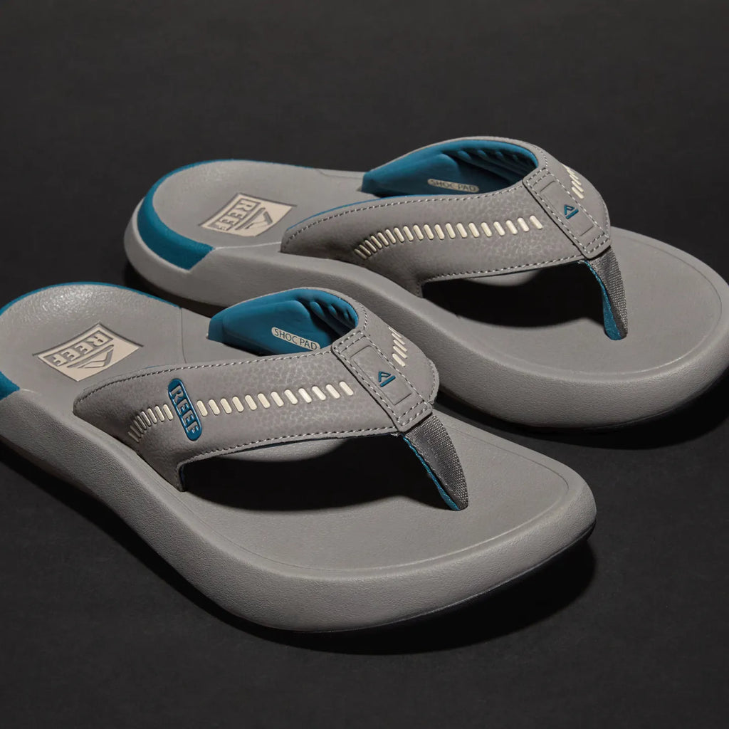 Cruiser men's grey flip flops facing right, showing cushioned toe post and breathable arch support straps with REEF tech.