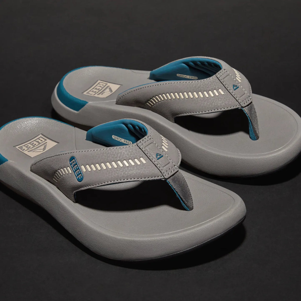 Cruiser men's grey flip flops facing right, showing cushioned toe post and breathable arch support straps with REEF tech.