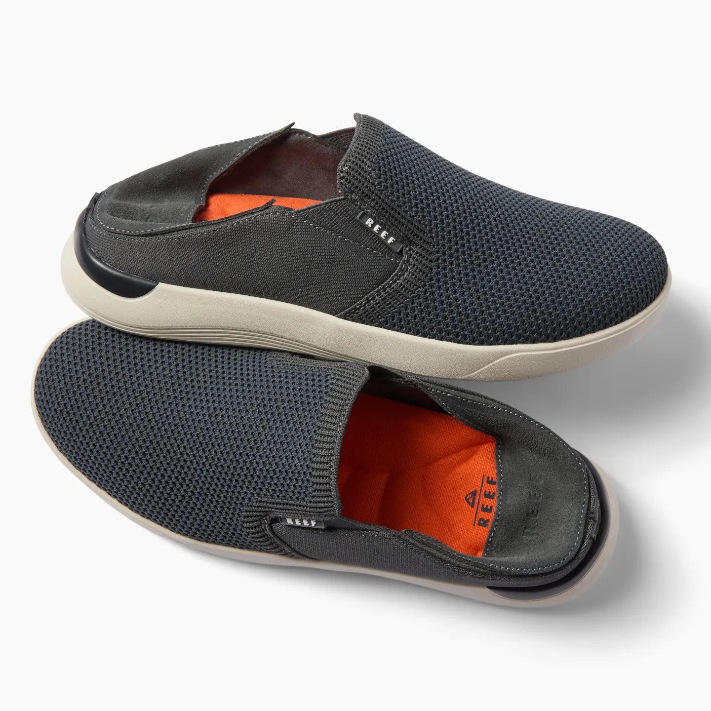 Top and side view of black Neptune Slip-On men's shoe with breathable mesh upper and cushioned orange insole, facing right.