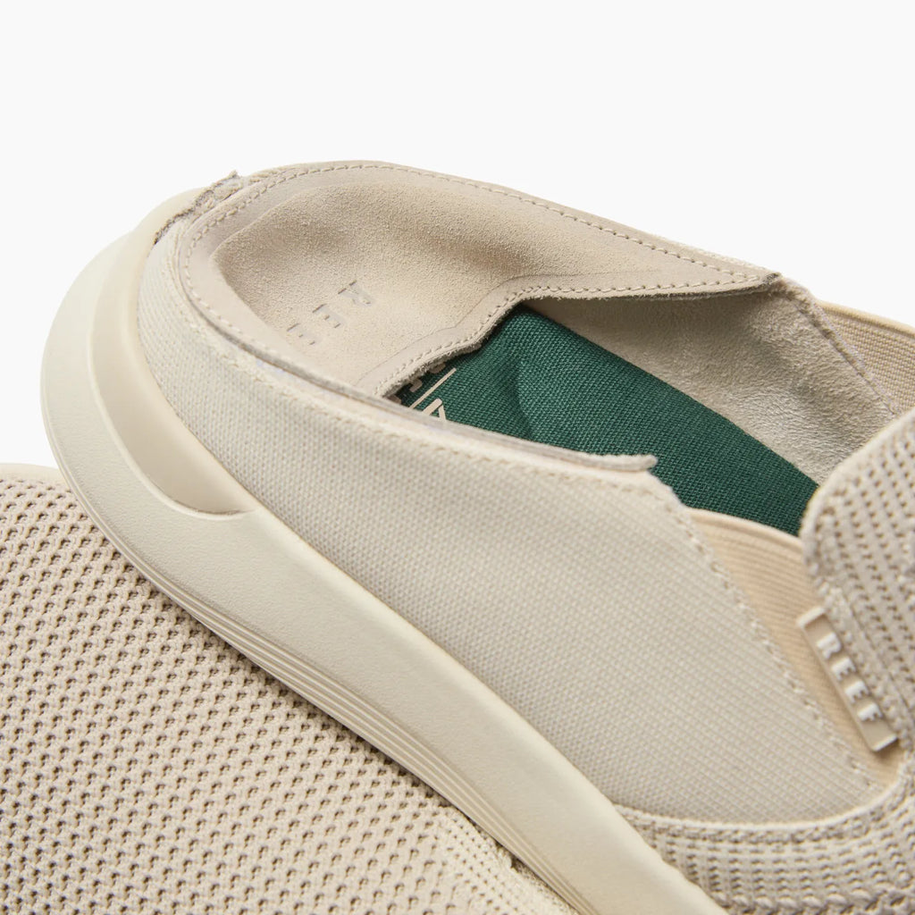 Close-up of the off-white Neptune Slip-On showing the heel and side facing left, highlighting comfort and durable design.