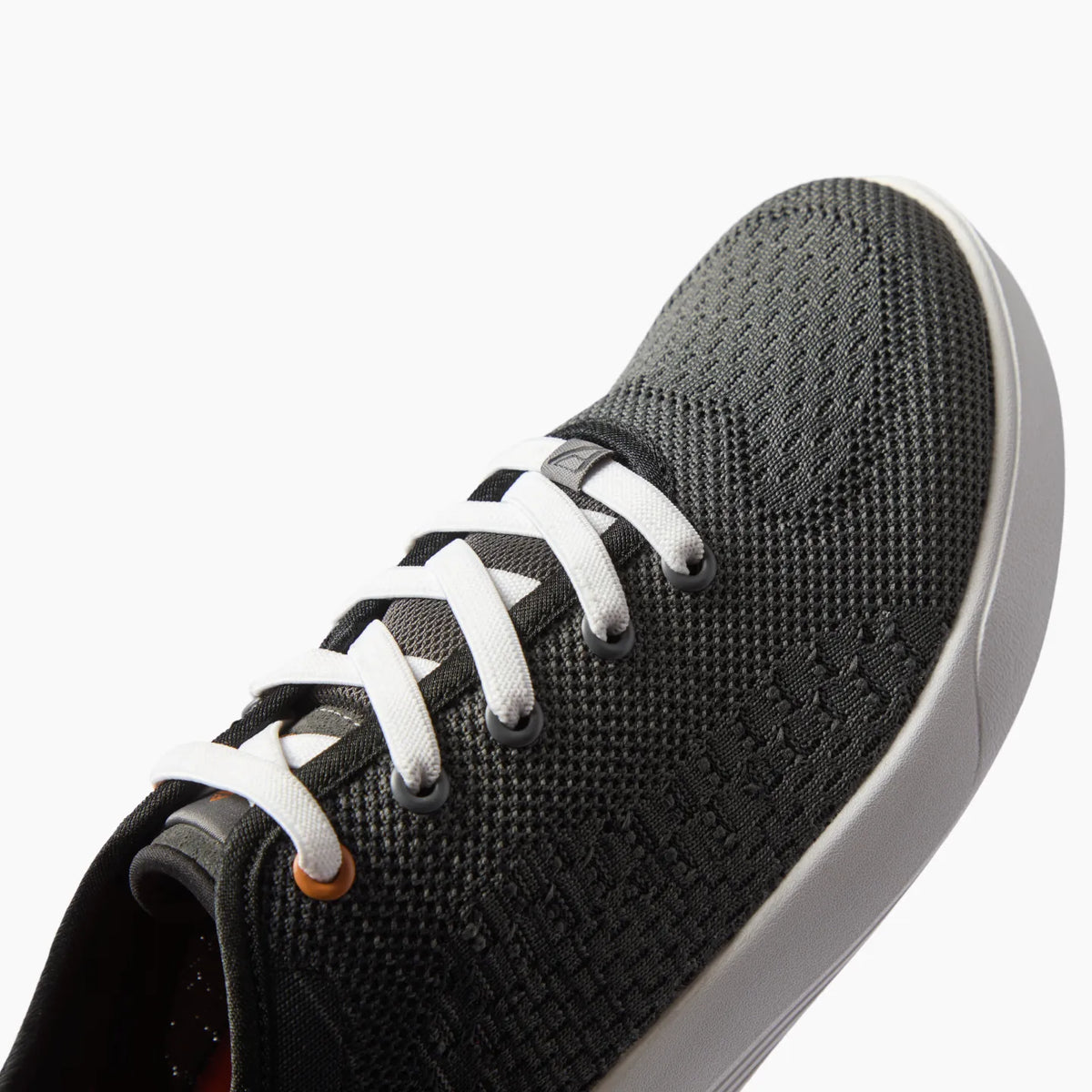 Neso men's black sneaker facing left, close-up on toe and upper mesh with cushioned sole for beach comfort