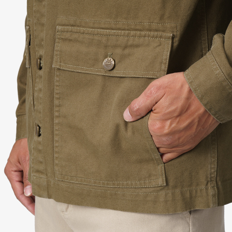 Close-up of the Landon Coat showing a hand in the front pocket, highlighting durable, beach-inspired comfort and design.