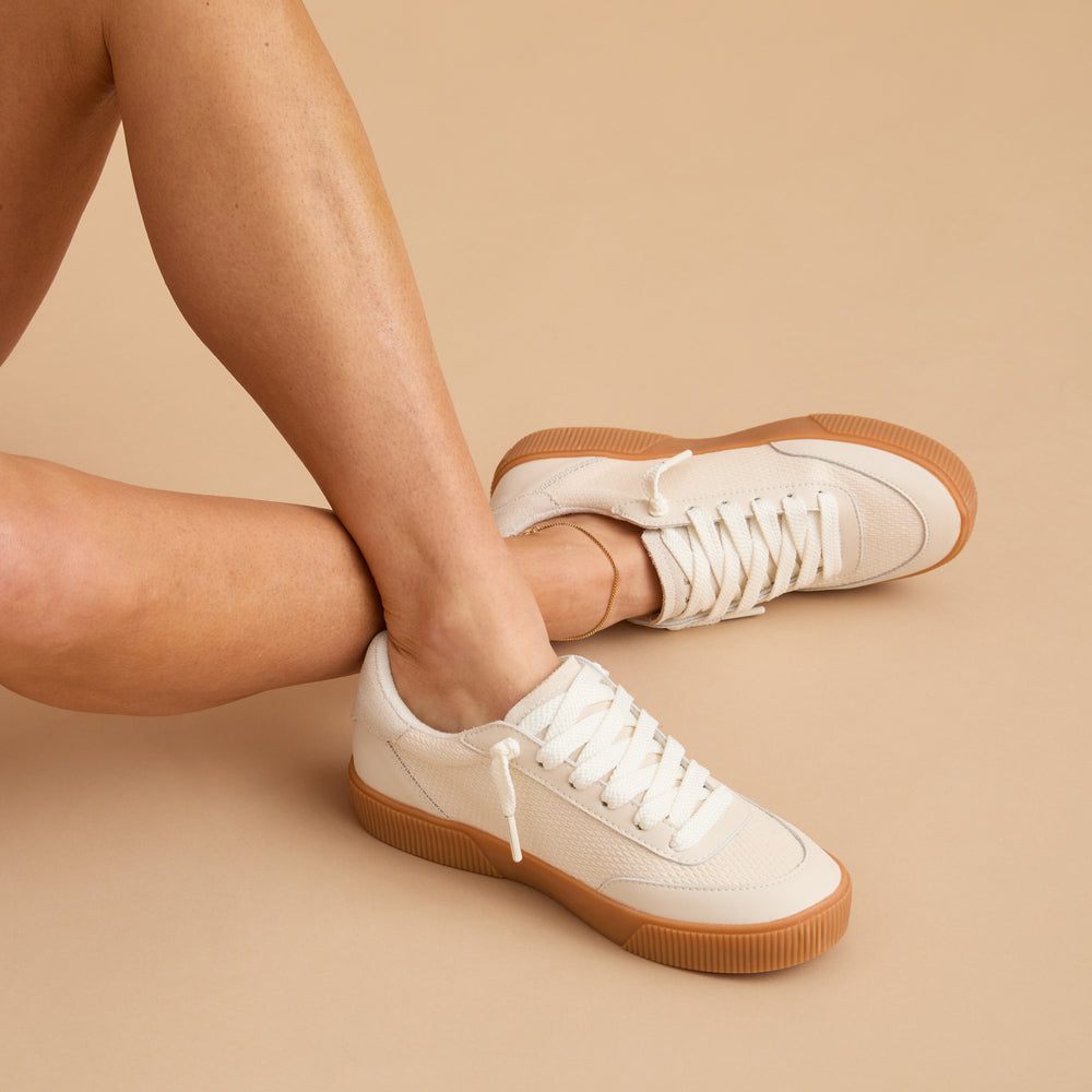 Lay Day Seas women's sneaker facing left, close-up on side and top showcasing cushioned, beach-inspired design.