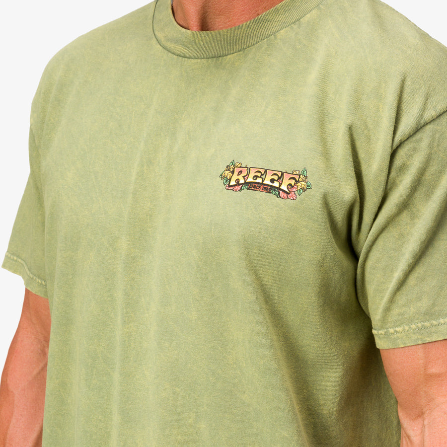 Close-up of a men's Lonnie Tee in mossstone green with small REEF logo on chest, designed for beach comfort and durability.