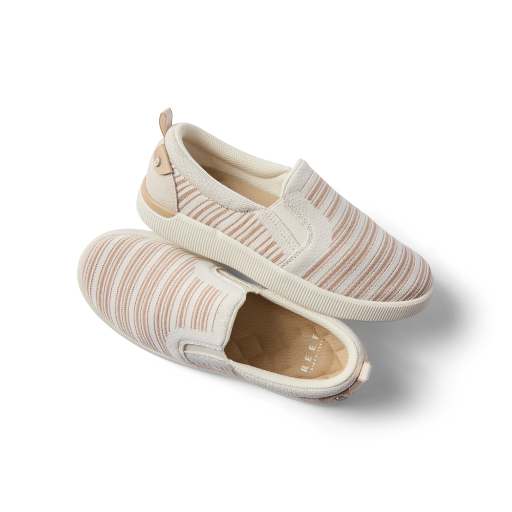Pair of Neptune Elyse women's slip-on shoes with tan stripe pattern, right shoe facing right, top shoe showing outsole, comfort-focused design.