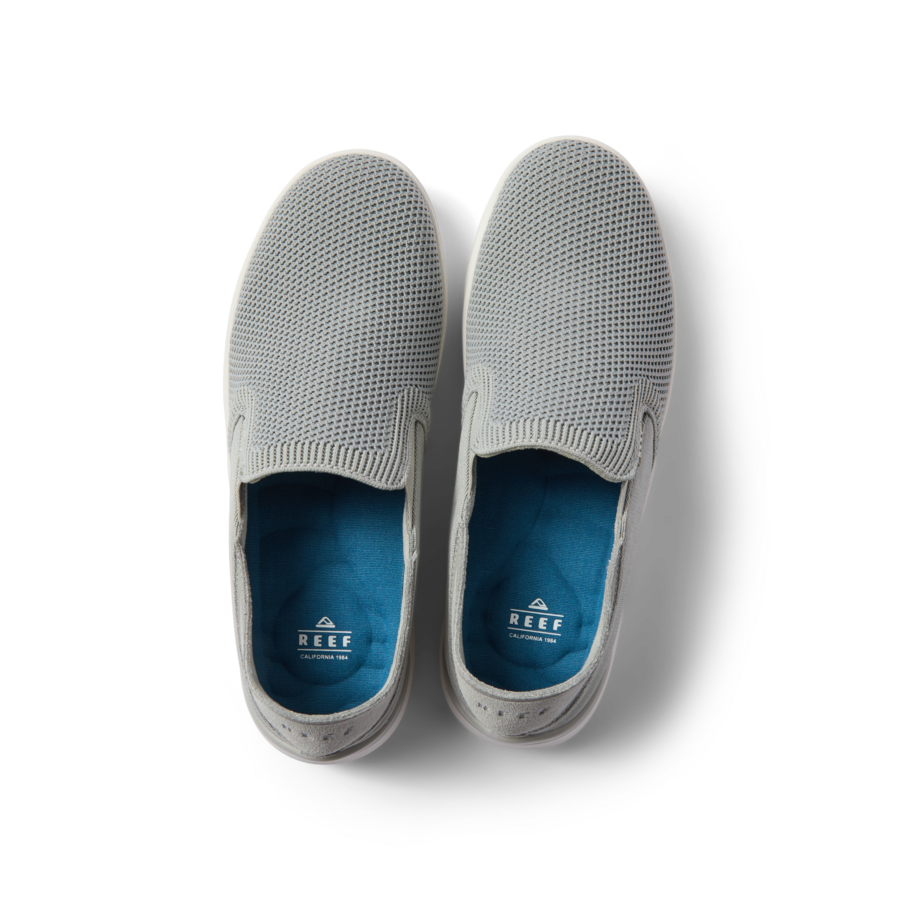 Top-down view of grey Neptune Slip-On shoes for men with mesh upper, blue cushioned insoles, and anatomical arch support.