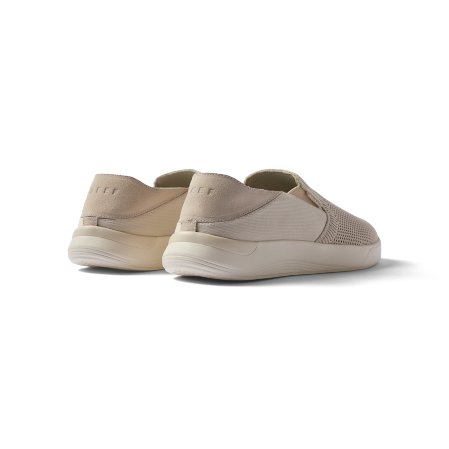 Pair of beige Neptune Slip-On shoes facing away, showing heel and side, featuring lightweight, water-friendly comfort.