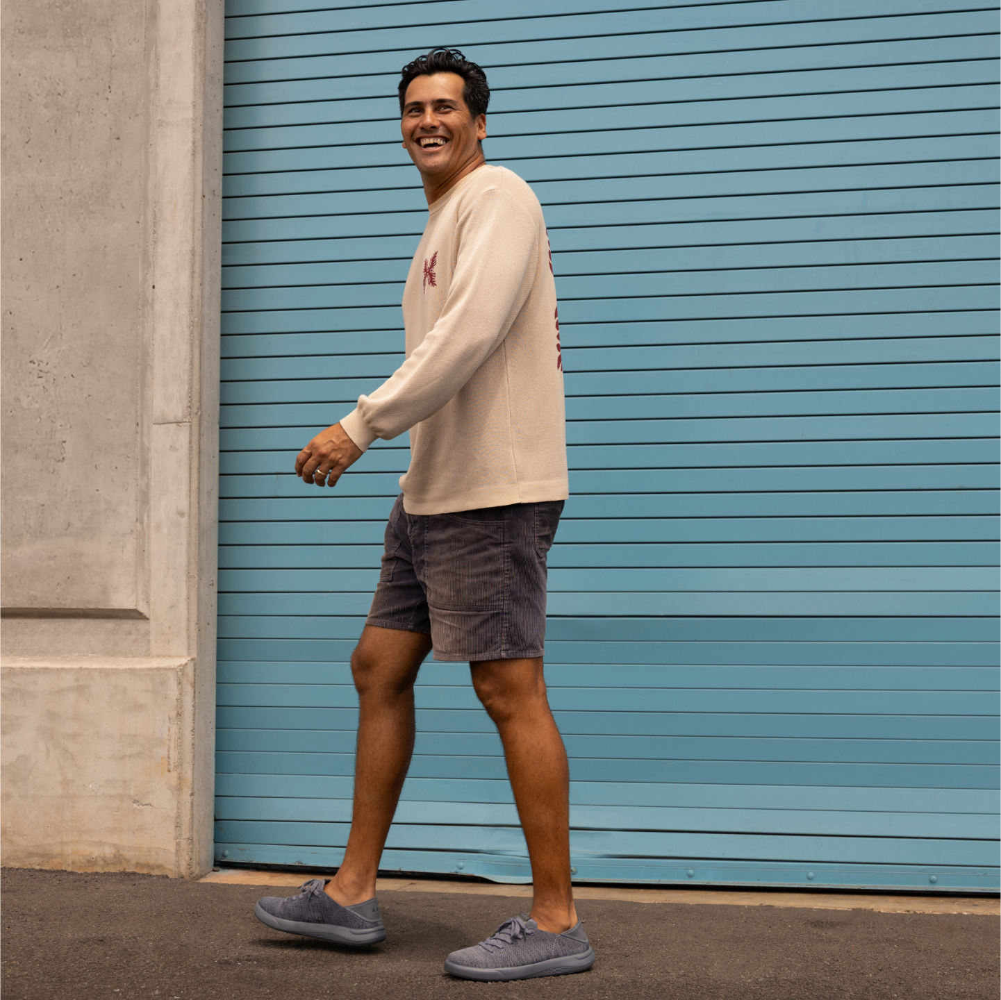 Man walking to the left wearing Neptune shoes, showcasing the side and top with comfort-focused design and beach-inspired style.