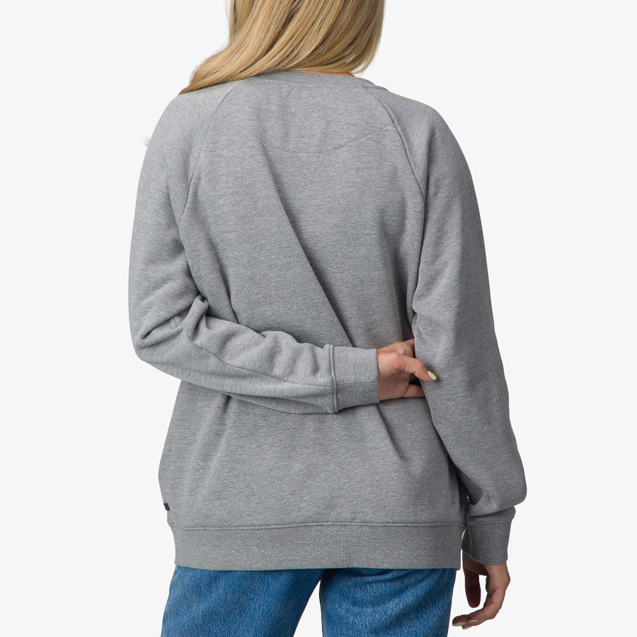 Woman wearing Oversized Raglan Fleece in heather grey, back view, highlighting comfortable beach-inspired casual apparel.