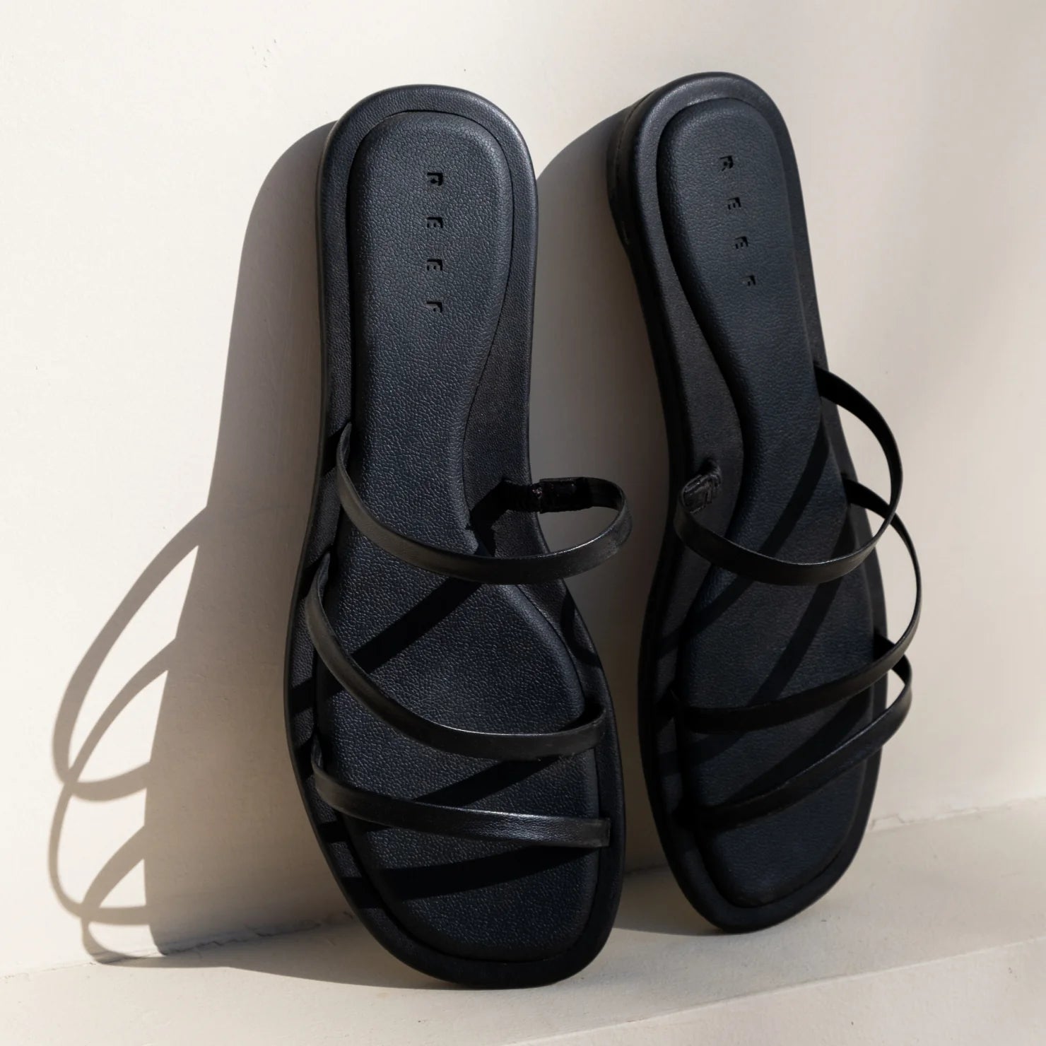 Willow Ava black women's sandals facing up, showing top view with thin straps and cushioned footbeds for beach comfort