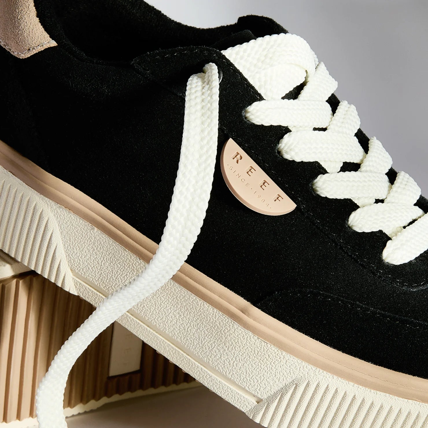 Close-up of the left side of Lay Day Lift sneaker facing right, featuring white laces and anatomical arch support.
