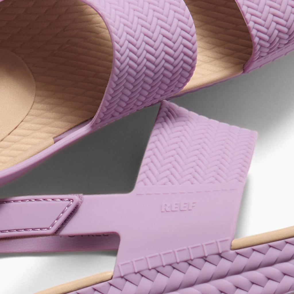 Close-up of Reef Water Vista women's sandals facing up, showing braided straps and cushioned footbed for comfort.