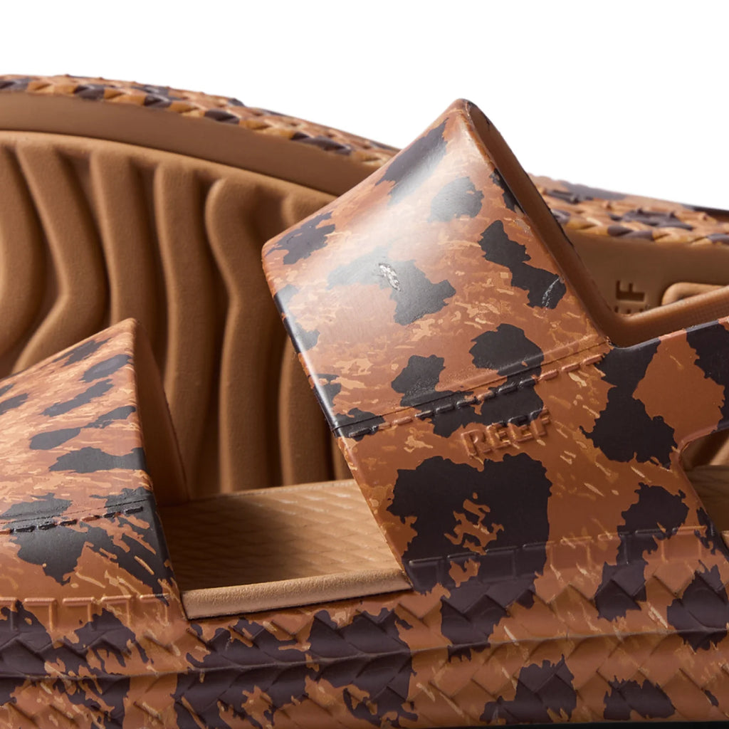 Close-up of the side and top straps of Reef Water Vista women's sandals facing left with animal print and water-friendly materials.