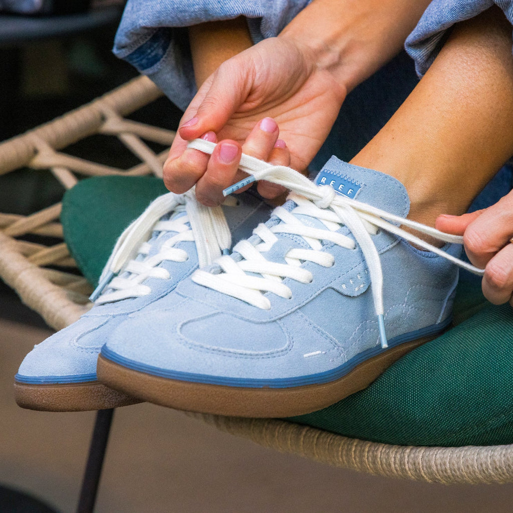 Boardwalk Callie women’s sneaker, facing forward, showing laces and soft light blue material with REEF branding