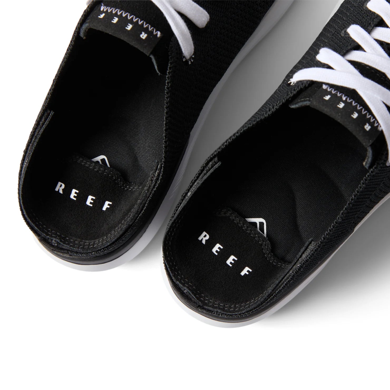 Close-up top view of the black Neptune HT shoes facing upward, showcasing REEF comfort and arch support.