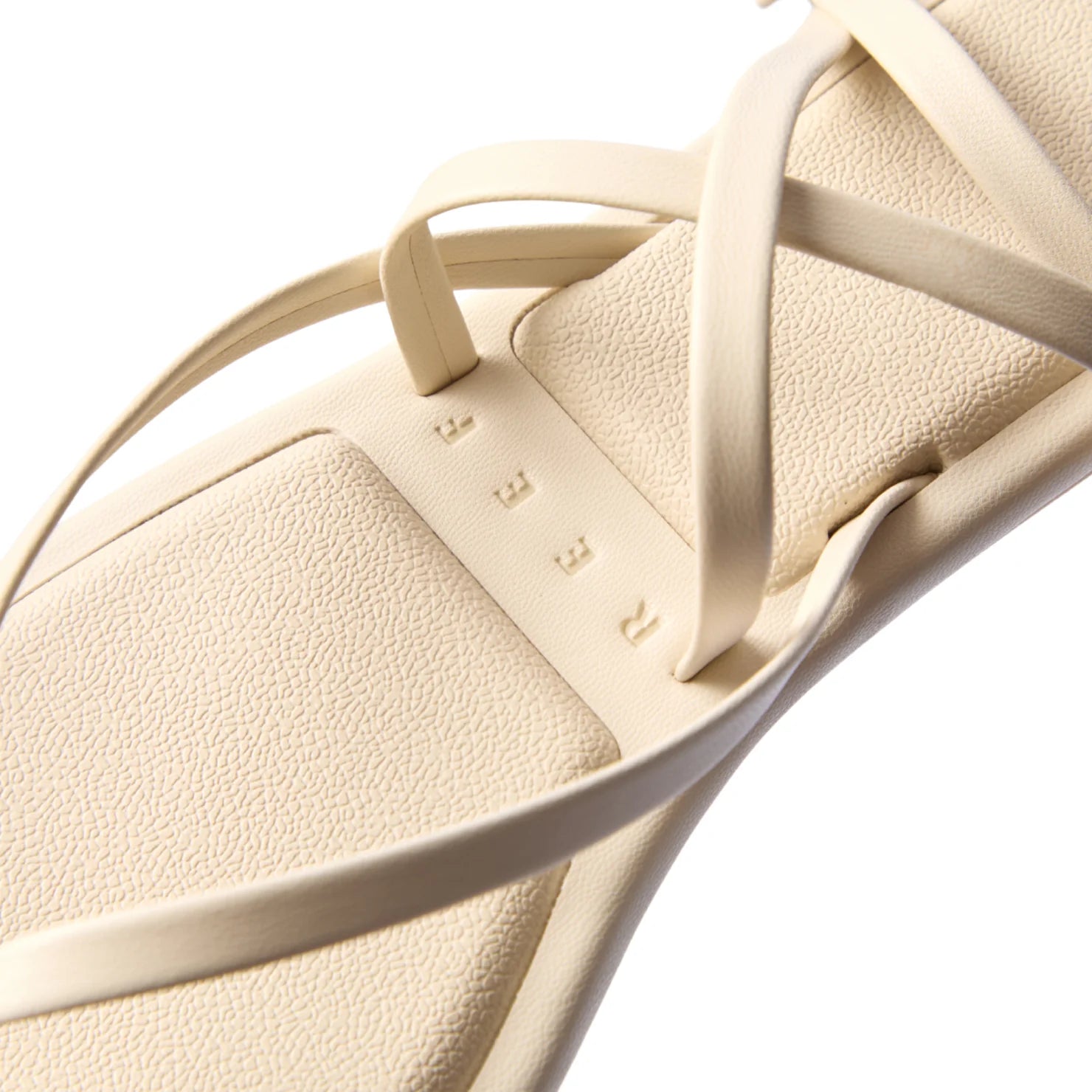 Willow Quinn close-up of the top footbed and delicate off-white vegan straps with textured cushioning and REEF branding