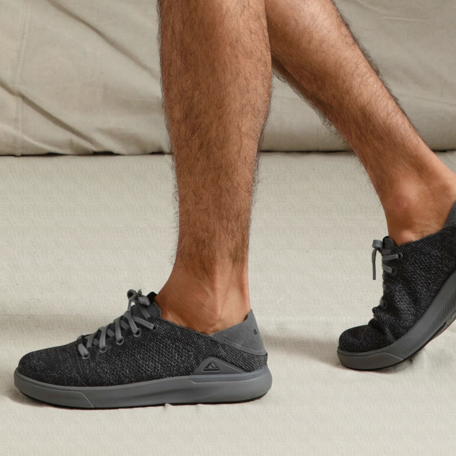 Neptune HT facing right on feet, men's black sneaker with lightweight knit upper, shaped sole, and arch support for comfort.