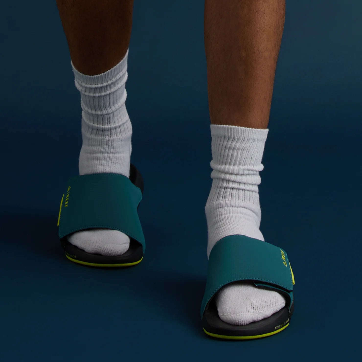 Front view of men's Cruiser Slide in ocean lime color, showing cushioned footbed and comfortable beach-inspired design.