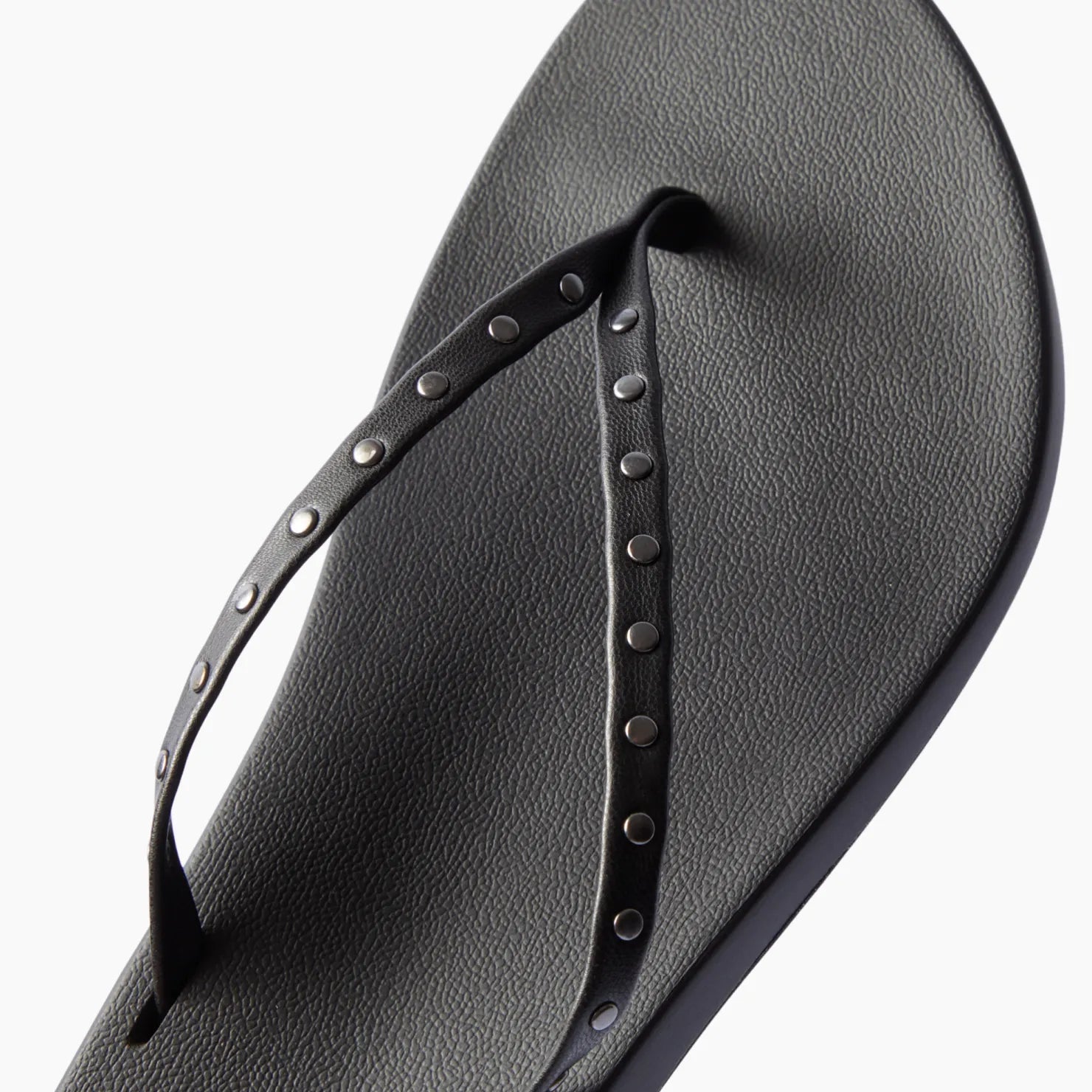 Top view of black Cushion Slim Studs sandal for women with studded straps and comfort cushioning for beachwear.